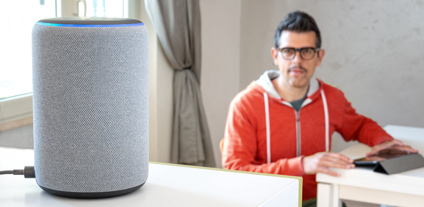 Man looking at Alexa Speaker