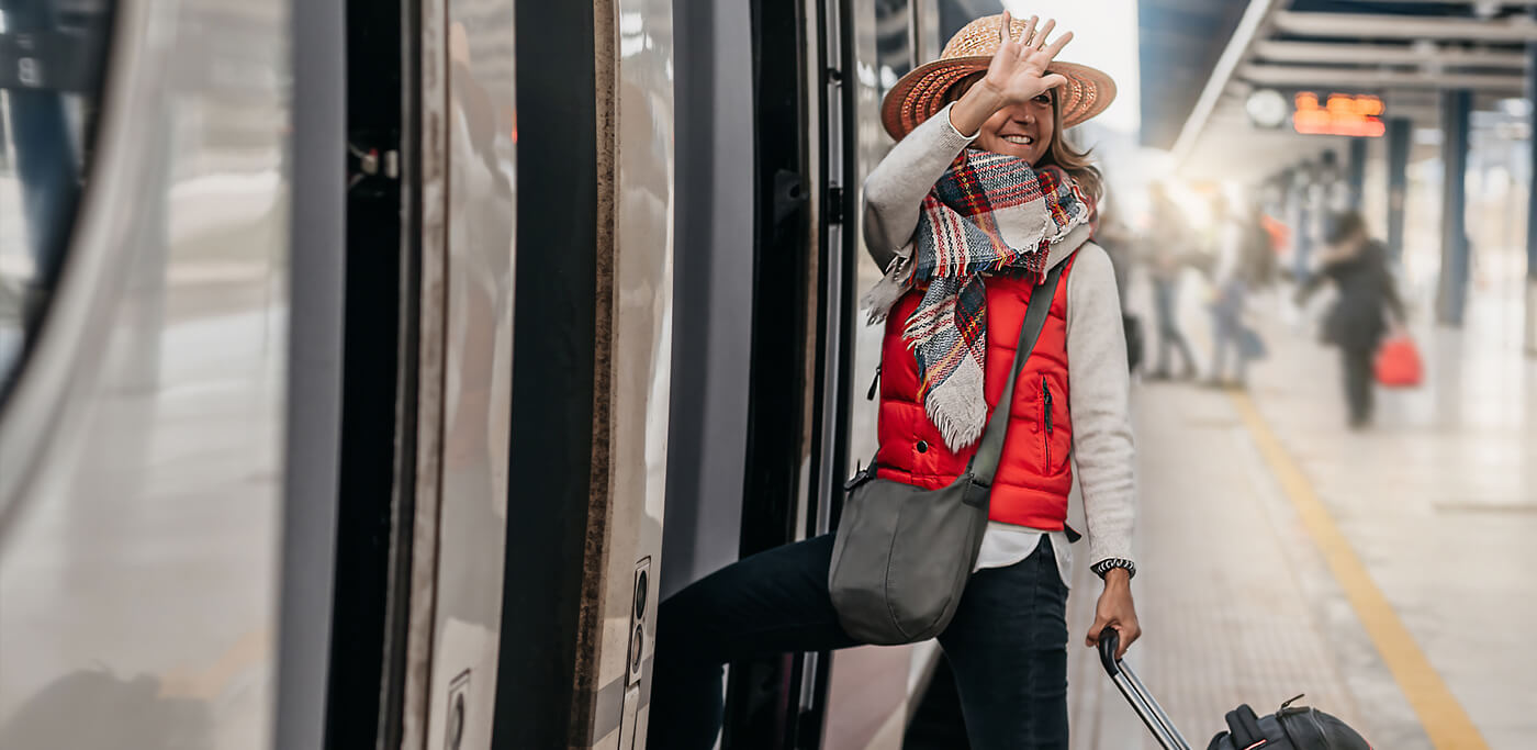 Women boarding train, saying goodbye