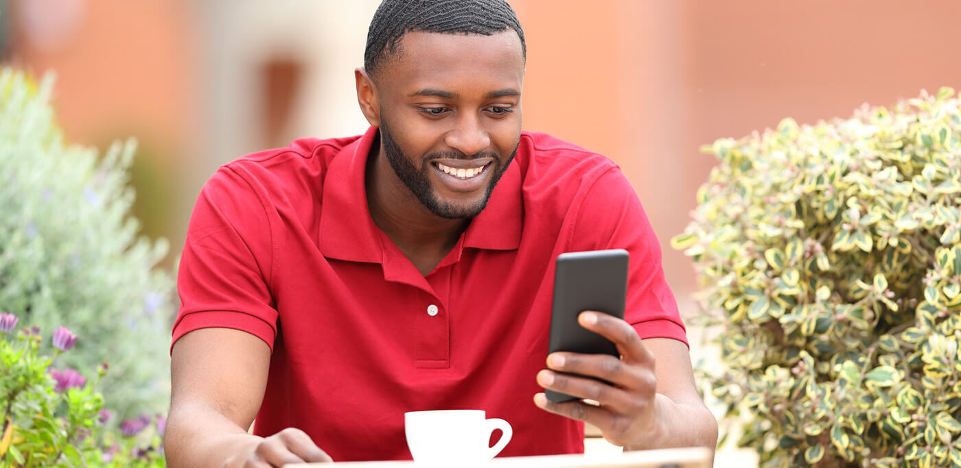 Happy man reading SMS messages