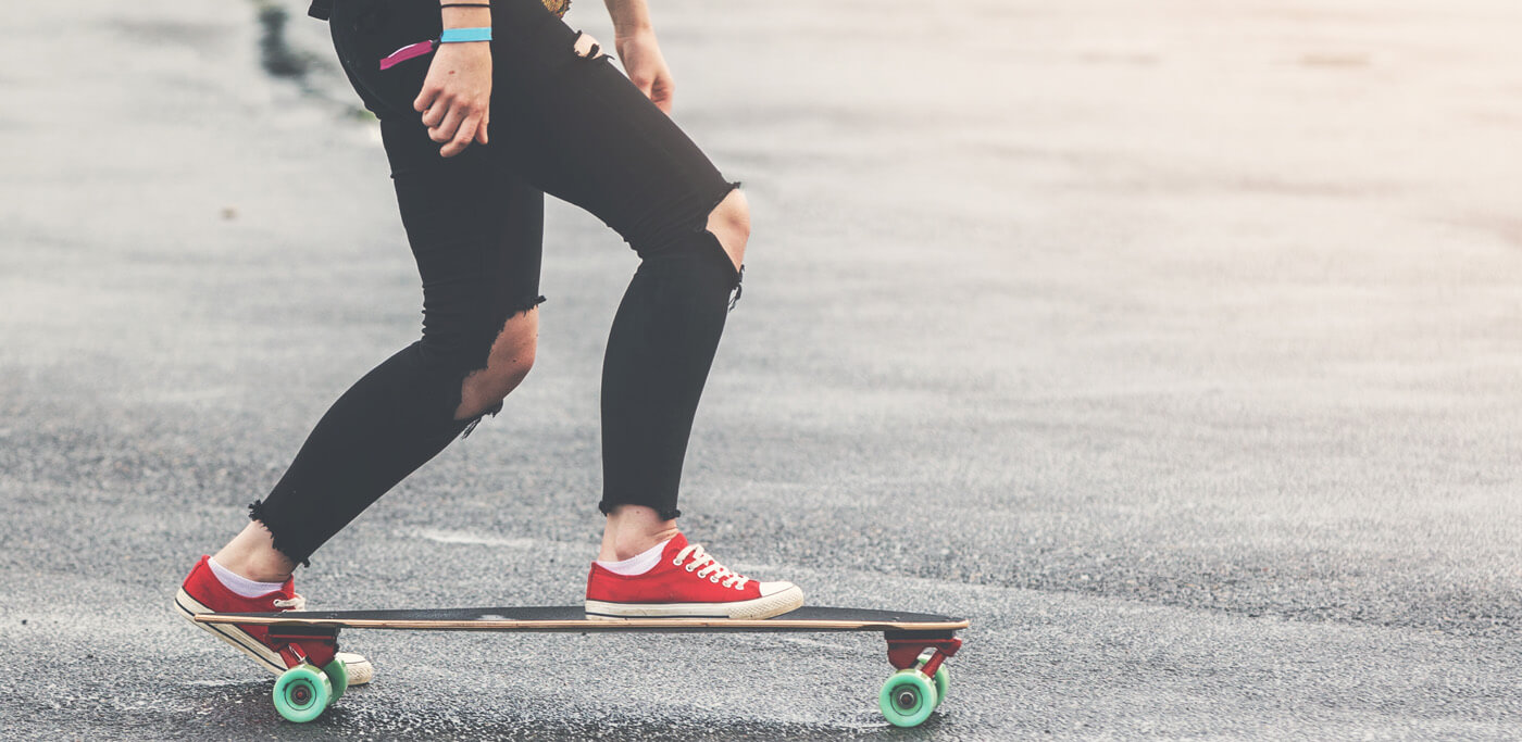 Women skateboarding in red trainers